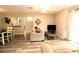 Living room with vinyl flooring, neutral paint, and sliding glass door for plenty of light at 320 N Bayshore Blvd # 208, Clearwater, FL 33759