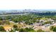 An aerial shot highlights a community near a cityscape, featuring lush green spaces and residential areas at 3211 E 23Rd Ave, Tampa, FL 33605