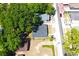 An aerial view showcases a home with a driveway, surrounded by mature trees and neighboring houses at 3211 E 23Rd Ave, Tampa, FL 33605