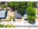 An aerial view showcases a cozy home surrounded by lush greenery and mature trees at 3211 E 23Rd Ave, Tampa, FL 33605