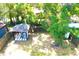 Aerial view showcases a backyard shaded by a mature tree with a covered seating area at 3211 E 23Rd Ave, Tampa, FL 33605