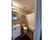 Bathroom features a sink with a vanity, a toilet, a shelving unit, and a shower/tub combo at 3211 E 23Rd Ave, Tampa, FL 33605