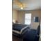 This bedroom features a ceiling fan, a window for natural light, a dresser with a TV, and a daybed at 3211 E 23Rd Ave, Tampa, FL 33605