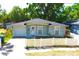 Charming exterior with a well-manicured lawn and white picket fence offers instant curb appeal at 3211 E 23Rd Ave, Tampa, FL 33605