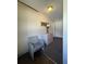Neutral hallway featuring a decorative vase on cabinet, and a wicker chair at 3211 E 23Rd Ave, Tampa, FL 33605