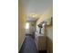 Inviting hallway featuring a mirror, decorative vase, neutral paint, and ceiling light fixture at 3211 E 23Rd Ave, Tampa, FL 33605