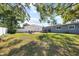 Large backyard with a wooden patio, well maintained lawn and surrounded by privacy fencing at 4105 W Fair Oaks Ave, Tampa, FL 33611
