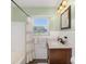 Bathroom with a shower/tub combination, wooden vanity, and a large window at 4105 W Fair Oaks Ave, Tampa, FL 33611