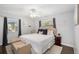Cozy bedroom featuring neutral tones, a ceiling fan, and a comfortable upholstered headboard at 4105 W Fair Oaks Ave, Tampa, FL 33611