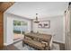 Cozy dining room with a rustic wooden table, bench seating, and a sliding door that opens to the backyard at 4105 W Fair Oaks Ave, Tampa, FL 33611