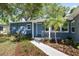 Charming home featuring a blue exterior, complemented by lush landscaping and a well-manicured front yard at 4105 W Fair Oaks Ave, Tampa, FL 33611