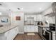 Stylish kitchen featuring white cabinetry, stainless steel appliances, and a functional layout at 4105 W Fair Oaks Ave, Tampa, FL 33611