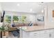 Contemporary kitchen featuring a breakfast bar with a seamless view into the living space at 4105 W Fair Oaks Ave, Tampa, FL 33611