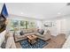 Comfortable living room with a large sectional, stylish rug, and ample natural light at 4105 W Fair Oaks Ave, Tampa, FL 33611