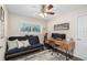 Functional home office with a futon, desk, and natural light, creating a productive workspace at 4105 W Fair Oaks Ave, Tampa, FL 33611