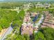 Stunning aerial view of a residential community with lush landscaping, a pond, and a fountain at 4206 Preserve Pl, Palm Harbor, FL 34685