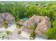 Aerial view of townhomes showcasing well-manicured lawns, palm trees, private driveways, and the community pool at 4206 Preserve Pl, Palm Harbor, FL 34685
