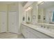 Bright bathroom with double sink vanity and neutral colored tile at 4206 Preserve Pl, Palm Harbor, FL 34685