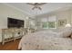 Bedroom features hardwood floors, natural lighting, and a ceiling fan at 4206 Preserve Pl, Palm Harbor, FL 34685