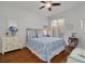 Comfortable bedroom with wood floors, a ceiling fan, and a sliding glass door to the outside at 4206 Preserve Pl, Palm Harbor, FL 34685