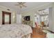 Bedroom features hardwood floors, and a ceiling fan and a sliding glass door to the deck at 4206 Preserve Pl, Palm Harbor, FL 34685