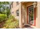 Charming front porch featuring a red door, sidelight and decorative flower wreath at 4206 Preserve Pl, Palm Harbor, FL 34685