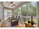Inviting lanai with wicker seating, wood floors, and serene views of the surrounding landscape at 4206 Preserve Pl, Palm Harbor, FL 34685