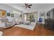 Open living room features hardwood floors, ceiling fan, and access to an enclosed lanai at 4206 Preserve Pl, Palm Harbor, FL 34685