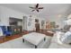 Spacious living room offers hardwood floors, a ceiling fan, and an adjacent kitchen at 4206 Preserve Pl, Palm Harbor, FL 34685