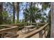 Wooden deck area featuring a picnic table and overlooking a scenic lake view at 4206 Preserve Pl, Palm Harbor, FL 34685