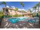 Inviting community pool area with lounge chairs and umbrella-covered tables, perfect for enjoying the Florida sunshine at 4206 Preserve Pl, Palm Harbor, FL 34685