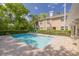 Well-maintained community pool surrounded by mature trees and manicured landscaping, offering a refreshing escape at 4206 Preserve Pl, Palm Harbor, FL 34685