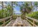 Scenic view of a lake from a wooden deck with picnic table offering a relaxing outdoor space at 4206 Preserve Pl, Palm Harbor, FL 34685