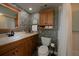 Charming bathroom featuring wallpaper, warm lighting, built in cabinet, and modern fixtures at 4910 Bay Ne St # 308, St Petersburg, FL 33703