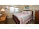 Comfortable bedroom with natural light, featuring a wooden bed frame and patterned quilt at 4910 Bay Ne St # 308, St Petersburg, FL 33703