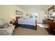 Cozy bedroom featuring a wooden bed frame, blue and white bedding, and classic wooden furniture at 4910 Bay Ne St # 308, St Petersburg, FL 33703