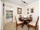 Dining area with dark wood table and view to the outdoor patio with a striped awning at 4910 Bay Ne St # 308, St Petersburg, FL 33703
