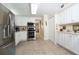 Spacious kitchen with white cabinetry, stainless steel appliances, and tile backsplash at 4910 Bay Ne St # 308, St Petersburg, FL 33703