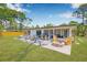 The backyard features a patio with a fire pit, grill, and outdoor seating at 4925 Camellia S Way, St Petersburg, FL 33705