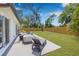 Private backyard features green lawn, a spa, grill, patio furniture, and wood fence at 4925 Camellia S Way, St Petersburg, FL 33705