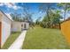 Spacious backyard featuring a well-maintained lawn and a patio area at 4925 Camellia S Way, St Petersburg, FL 33705