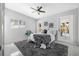 Bright bedroom featuring ceiling fan, stylish furnishings, and view to exterior at 4925 Camellia S Way, St Petersburg, FL 33705