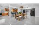 Bright dining area with terrazzo flooring, adjacent kitchen, and modern lighting at 4925 Camellia S Way, St Petersburg, FL 33705