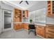Built-in home office nook with generous natural light and workspace, featuring wooden cabinetry at 4925 Camellia S Way, St Petersburg, FL 33705