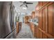 Bright kitchen with stainless appliances and wood cabinets transitions into the dining area at 4925 Camellia S Way, St Petersburg, FL 33705