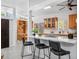 Open kitchen featuring wood cabinets, breakfast bar, modern countertops, and stainless steel appliances at 4925 Camellia S Way, St Petersburg, FL 33705