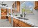Kitchen sink with window view, natural light, wooden cabinetry, and modern fixtures at 4925 Camellia S Way, St Petersburg, FL 33705