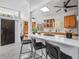 Bright open kitchen featuring wood cabinets, breakfast bar, modern countertops, and stainless steel appliances at 4925 Camellia S Way, St Petersburg, FL 33705