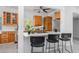 Kitchen featuring wood cabinets, quartz countertops, breakfast bar, and stainless steel appliances at 4925 Camellia S Way, St Petersburg, FL 33705