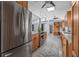 Bright kitchen with stainless steel appliances, wood cabinets, and seamless countertop stove at 4925 Camellia S Way, St Petersburg, FL 33705